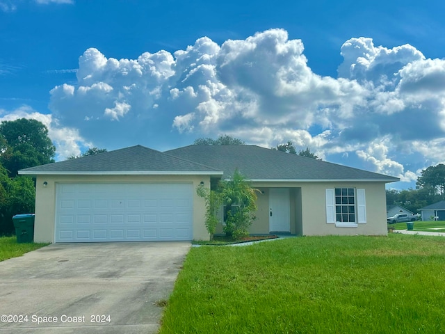 view of front of home with a front lawn and a garage