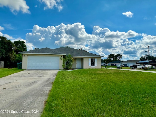 view of front of house featuring a garage and a front lawn