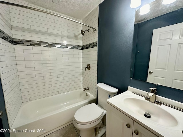 full bathroom featuring vanity, tiled shower / bath combo, tile patterned flooring, a textured ceiling, and toilet