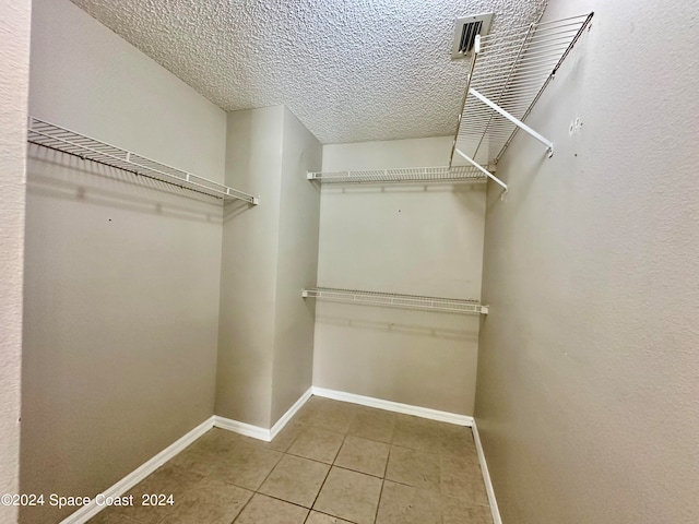 spacious closet with tile patterned flooring