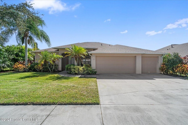 view of front of property with a front yard and a garage