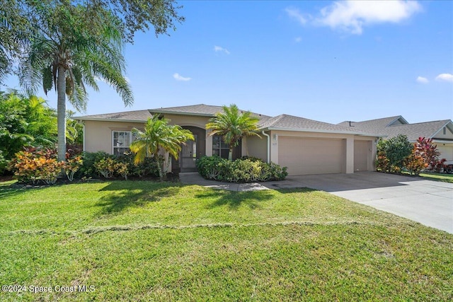 ranch-style house featuring a front lawn and a garage