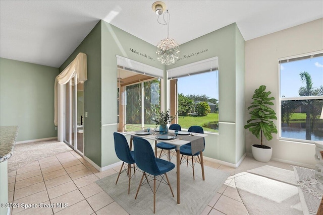 tiled dining area with a water view, a notable chandelier, and a healthy amount of sunlight