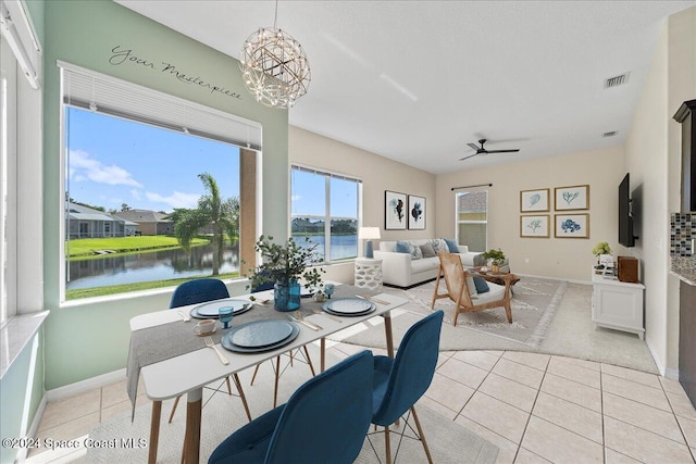 dining area featuring ceiling fan with notable chandelier and light tile patterned floors