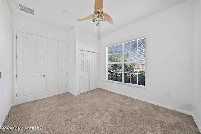 unfurnished bedroom featuring carpet floors and ceiling fan