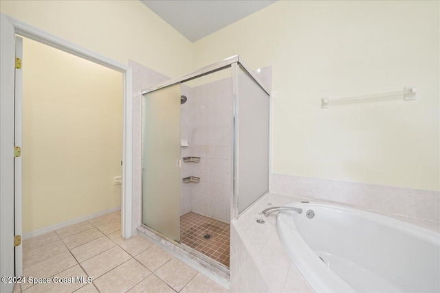 bathroom with separate shower and tub and tile patterned flooring