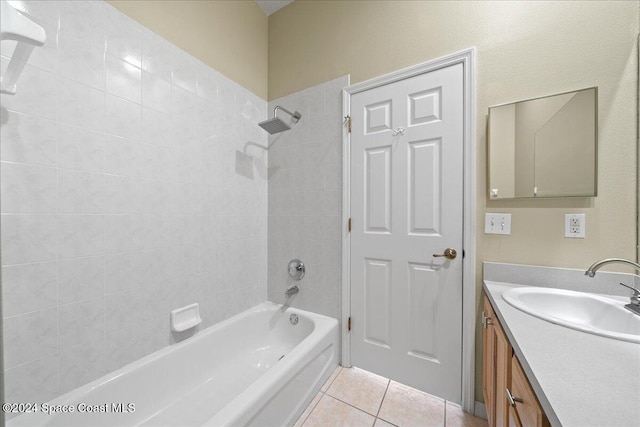 bathroom with vanity, tile patterned floors, and tiled shower / bath