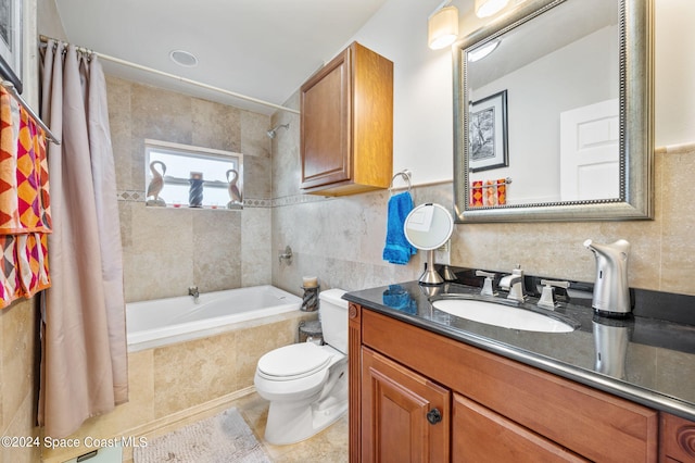 full bathroom with tile walls, toilet, vanity, shower / tub combo with curtain, and tile patterned floors