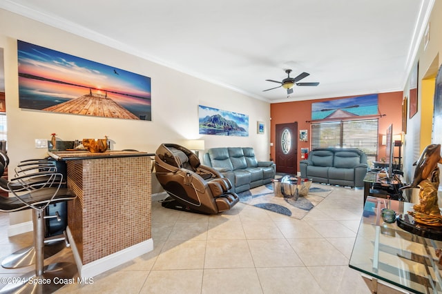 living room featuring crown molding, light tile patterned flooring, and ceiling fan