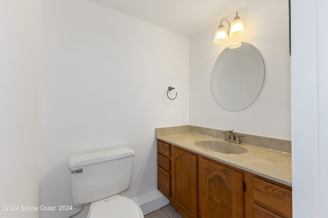 bathroom with tile patterned floors, vanity, and toilet