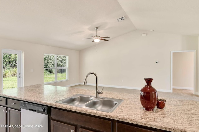 kitchen with lofted ceiling, dark brown cabinetry, sink, and dishwasher