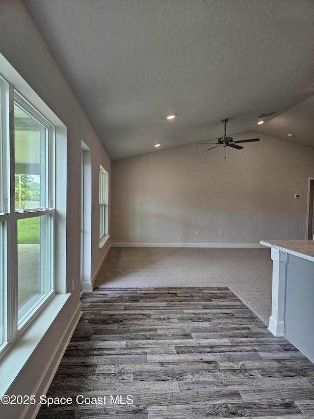 843 Geary St SW, Palm Bay, FL 32908 - spare room with ceiling fan, baseboards, dark wood-style floors, recessed lighting, and lofted ceiling