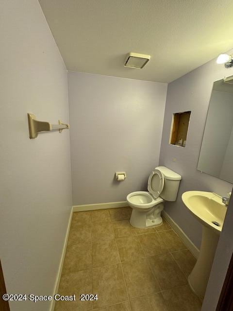 bathroom featuring tile patterned flooring and toilet