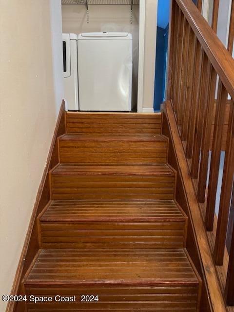 staircase featuring separate washer and dryer