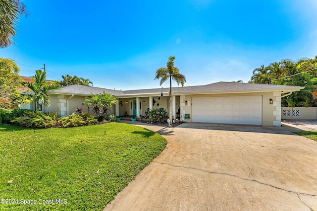 ranch-style home with a garage and a front yard