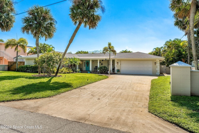 ranch-style home with a garage and a front lawn