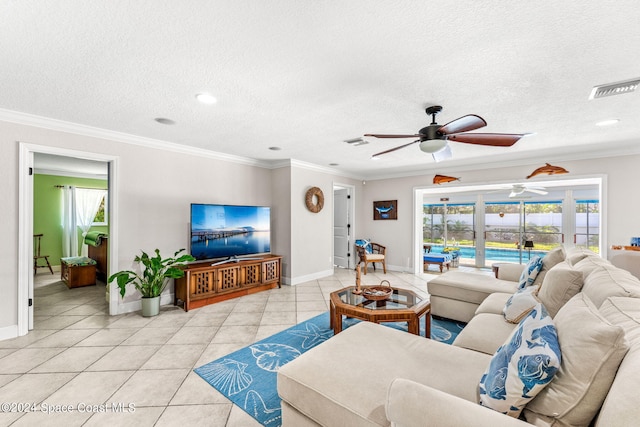 living room featuring ornamental molding, light tile patterned flooring, and a textured ceiling