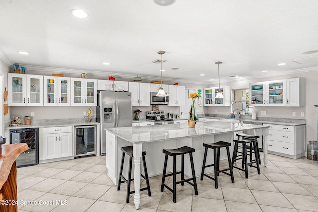 kitchen with white cabinets, wine cooler, and appliances with stainless steel finishes