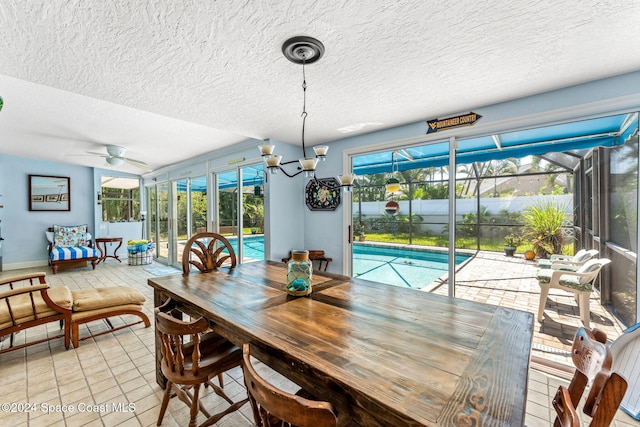 dining space with light tile patterned floors, a textured ceiling, and ceiling fan