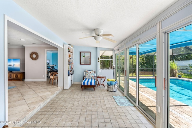 unfurnished sunroom with ceiling fan