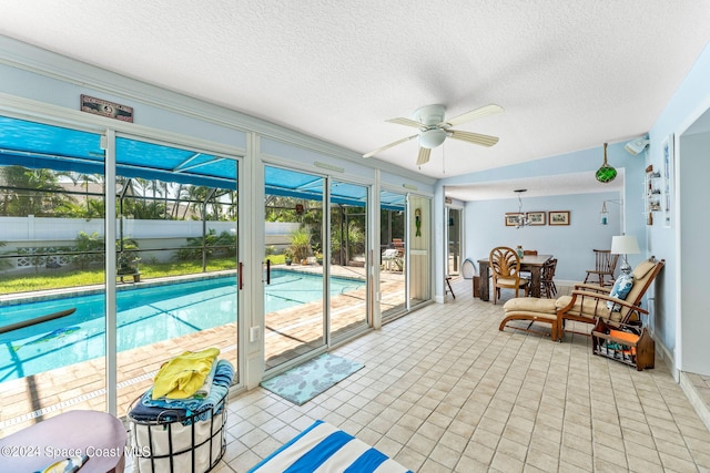 sunroom featuring ceiling fan