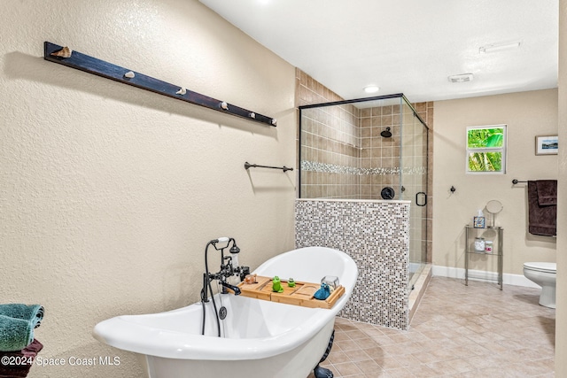 bathroom featuring shower with separate bathtub and toilet