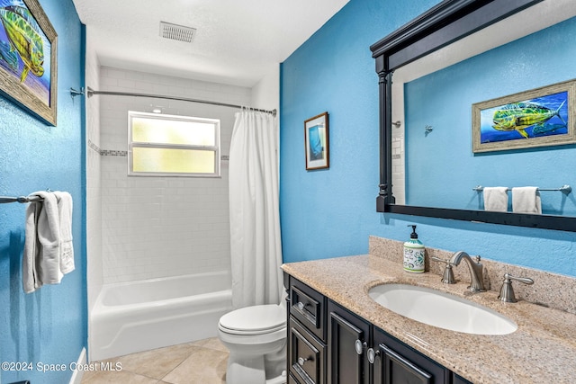 full bathroom with tile patterned flooring, toilet, shower / bathtub combination with curtain, vanity, and a textured ceiling