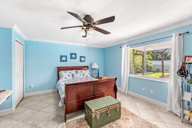 tiled bedroom with ceiling fan, a textured ceiling, a closet, and crown molding