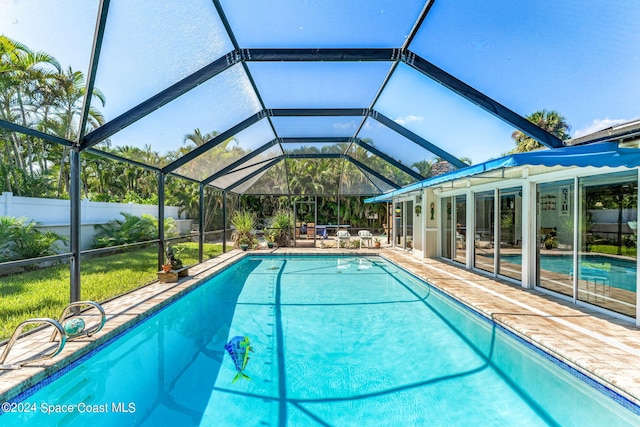 view of pool with a patio and glass enclosure