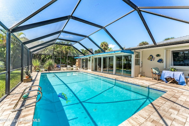 view of pool featuring a lanai and a patio area