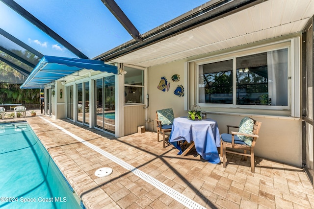 exterior space with glass enclosure and a patio area