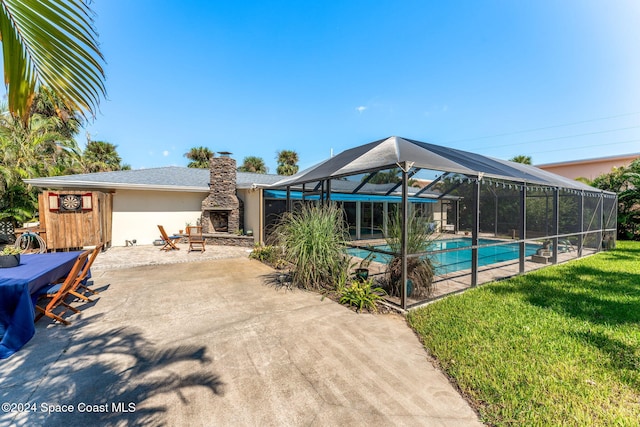 view of pool featuring a lanai, a patio, and a lawn