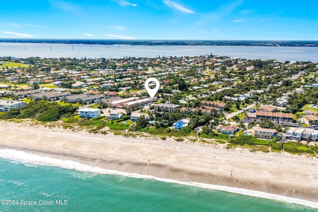 birds eye view of property featuring a beach view and a water view