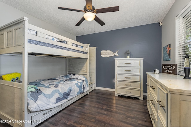 bedroom with a textured ceiling, dark hardwood / wood-style floors, and ceiling fan