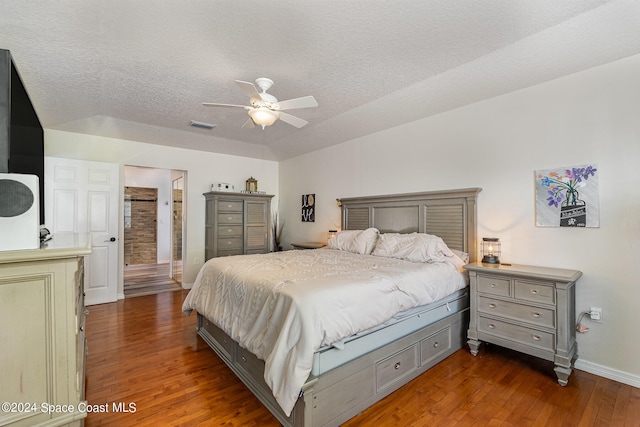 bedroom featuring a textured ceiling, dark wood-type flooring, and ceiling fan