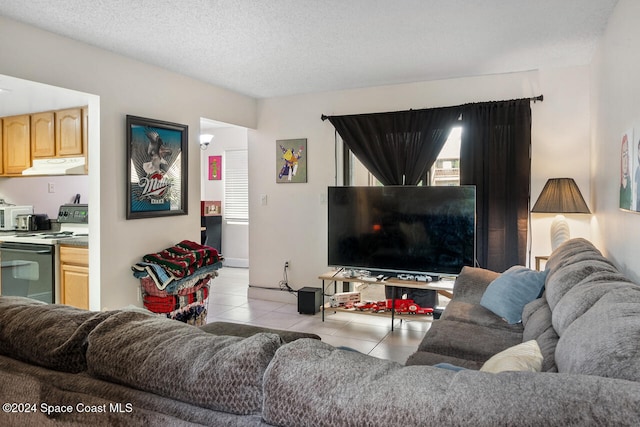 living room with a textured ceiling and light tile patterned floors