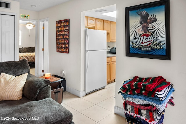 tiled living room with ceiling fan