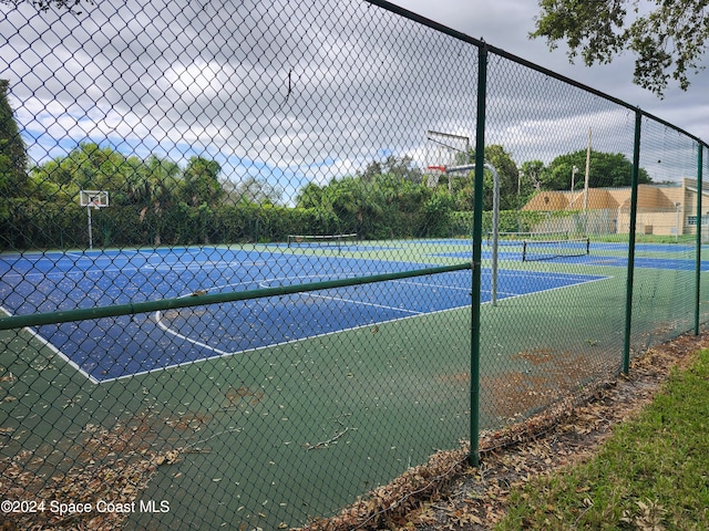 view of tennis court featuring basketball court