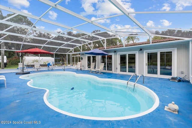 view of pool with a patio, french doors, and glass enclosure