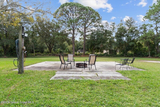 view of yard featuring a patio and a fire pit