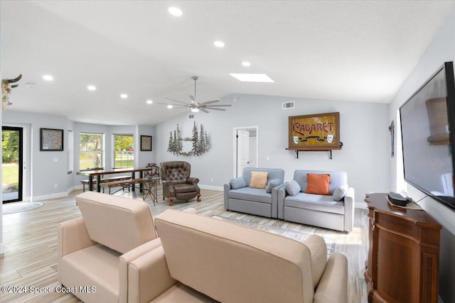 living room featuring lofted ceiling, light wood-type flooring, and ceiling fan