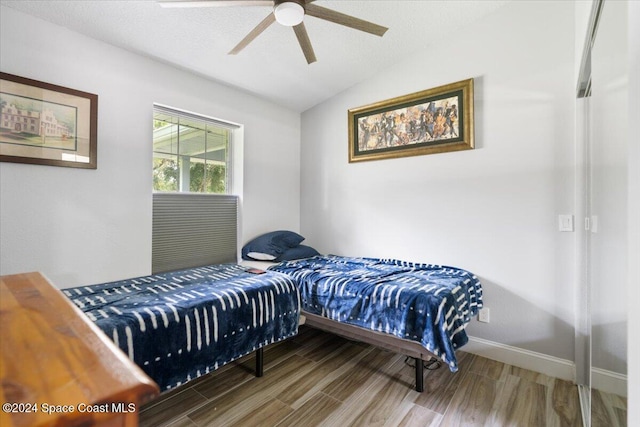 bedroom featuring lofted ceiling, hardwood / wood-style floors, and ceiling fan