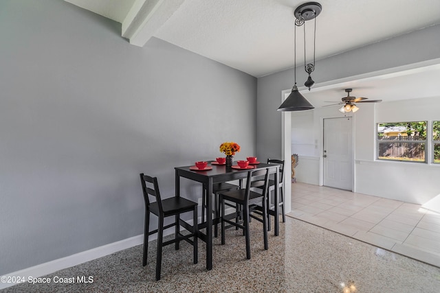 dining space with ceiling fan, a textured ceiling, and beam ceiling