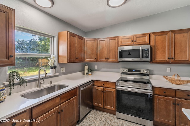 kitchen with a wealth of natural light, sink, and appliances with stainless steel finishes