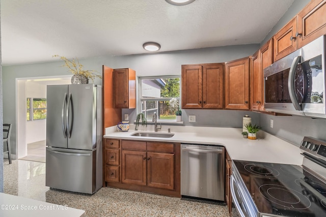 kitchen with sink, appliances with stainless steel finishes, and a textured ceiling