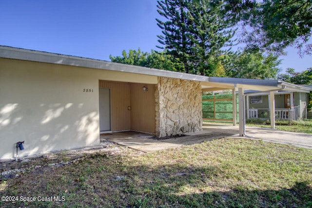 entrance to property with a yard