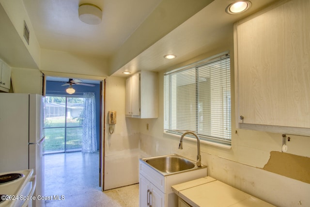 kitchen featuring white cabinetry, ceiling fan, sink, and white appliances