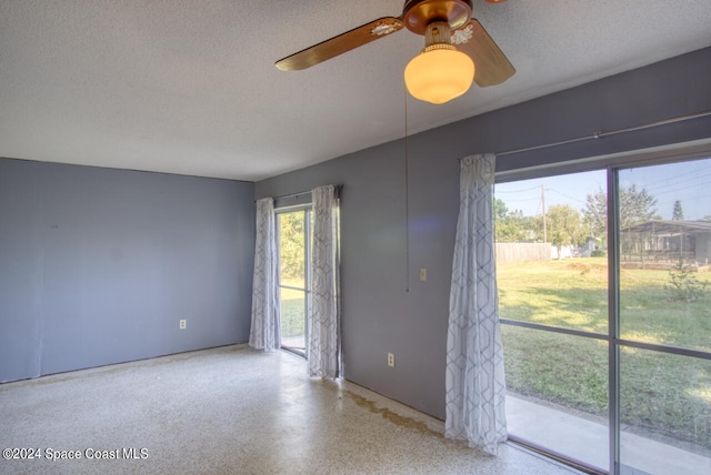 spare room with a textured ceiling and ceiling fan