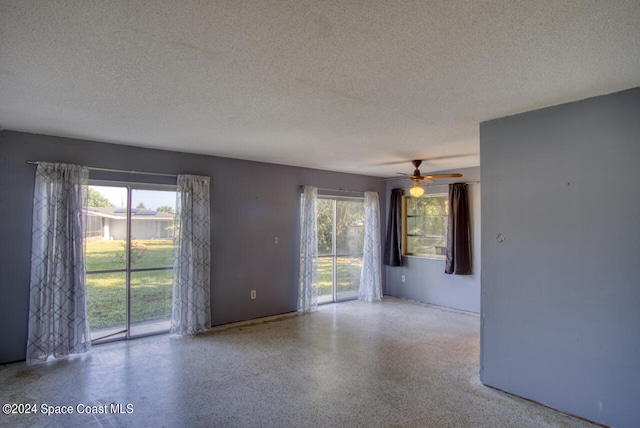 unfurnished room with a textured ceiling and ceiling fan