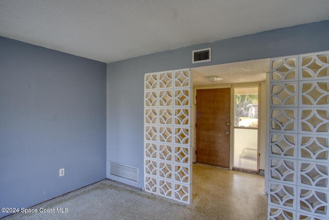 spare room with a textured ceiling